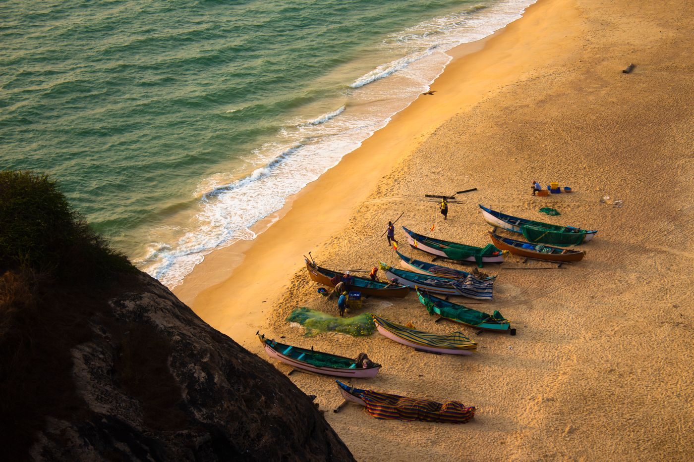 Aerial view of fishing boats on a golden beach
