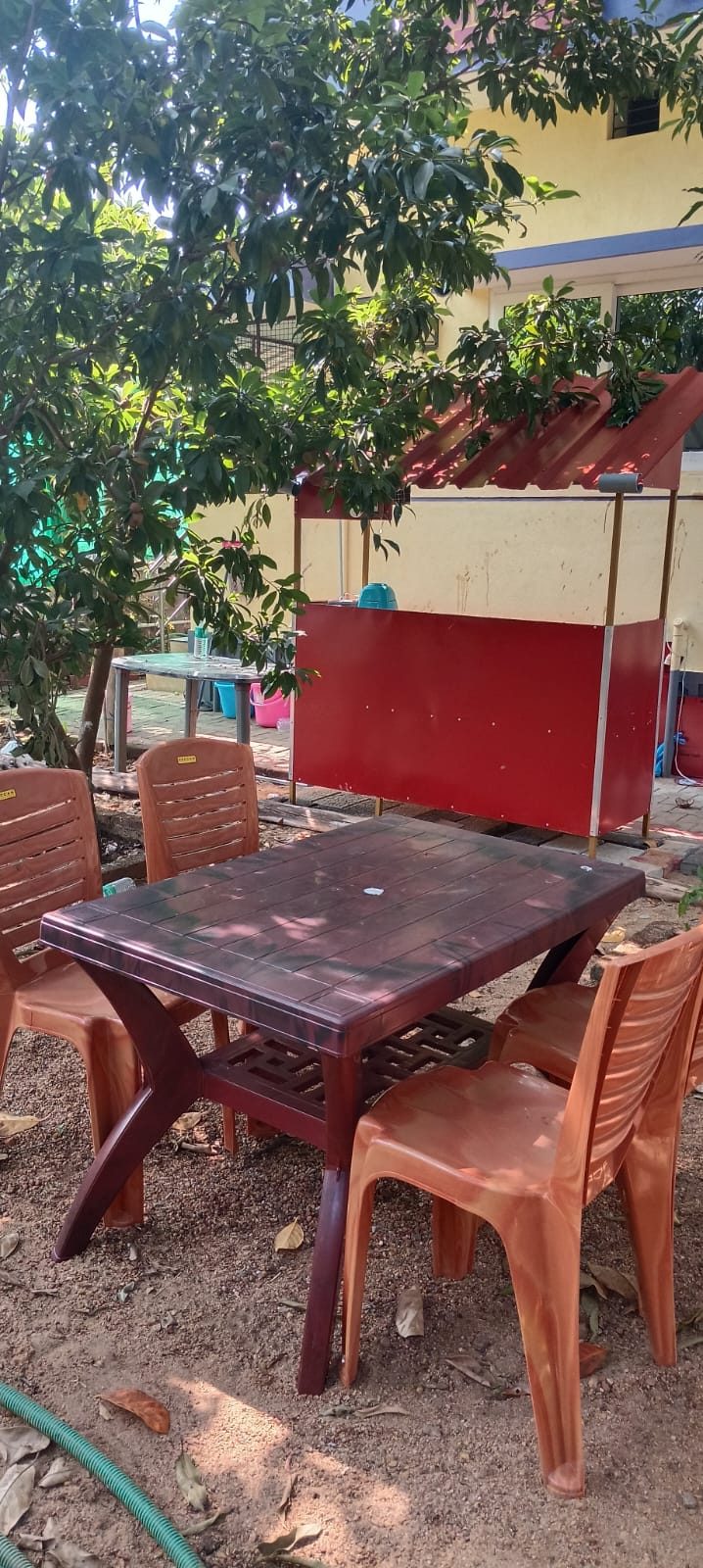 Outdoor dining table in the garden under trees