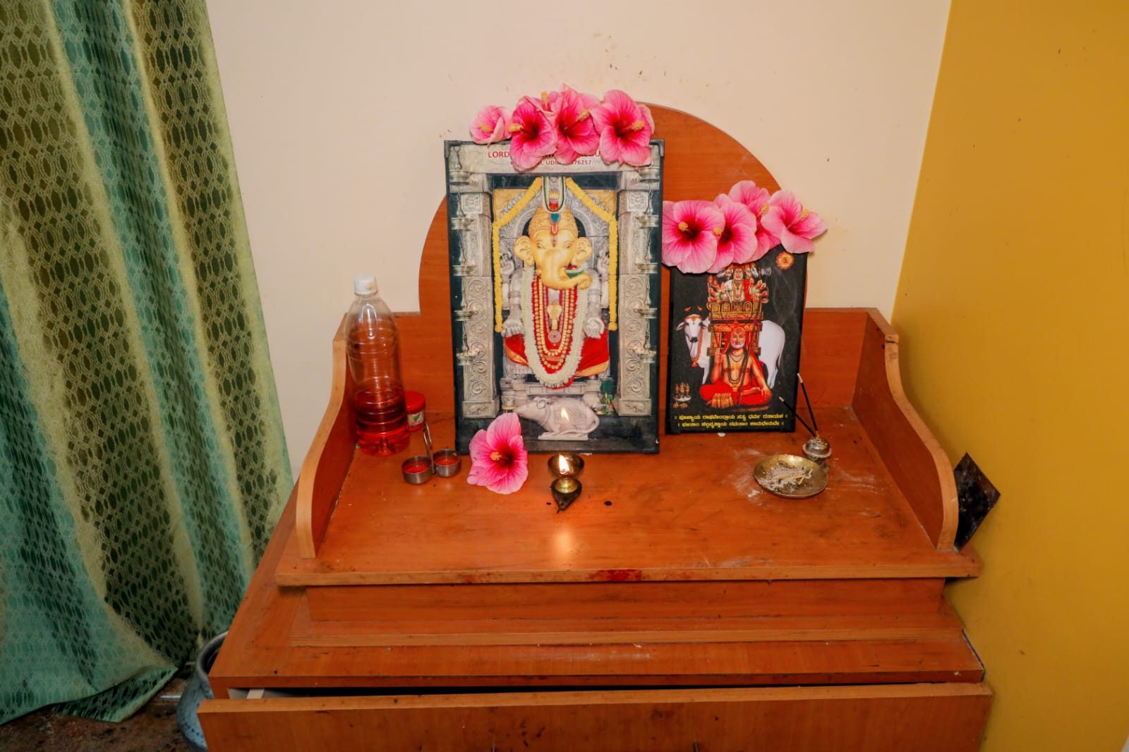 Traditional pooja corner with deities and lamp