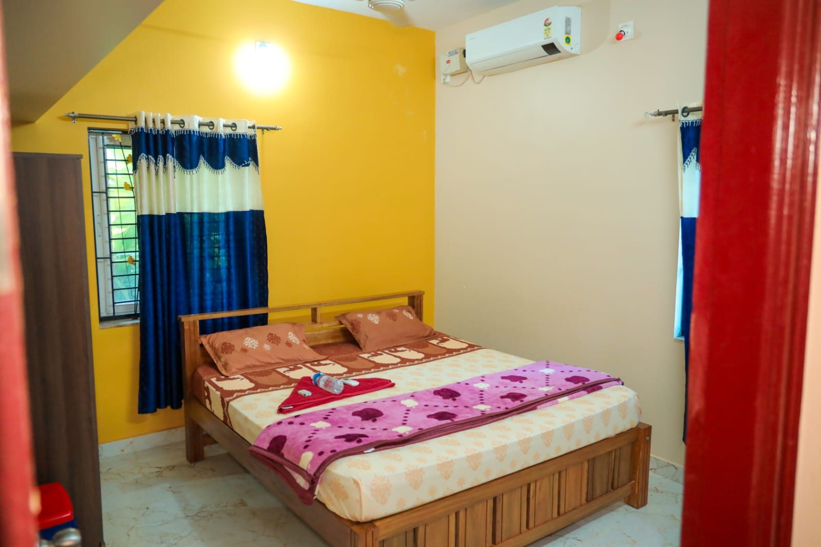 Second bedroom with double bed and large windows