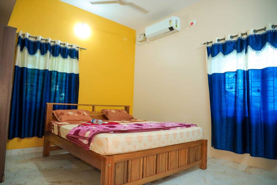 Bedroom with AC and blue curtains