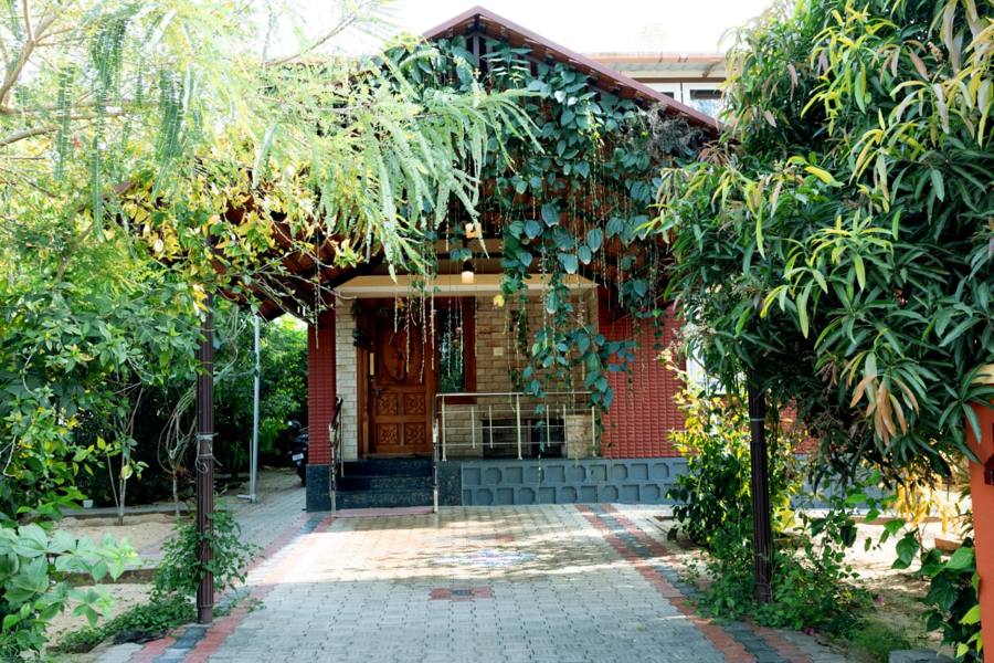 Brick homestay surrounded by greenery