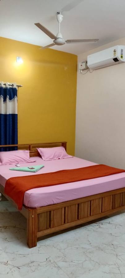 Bedroom with AC and yellow walls