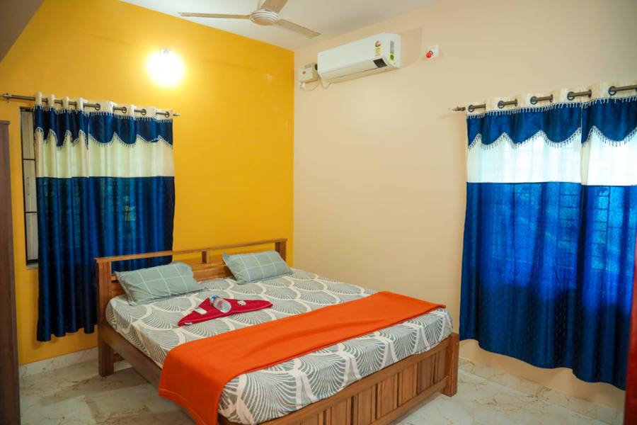 Bedroom with double bed and blue curtains